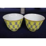 A pair of Chinese yellow glazed tea bowls, height 5cm