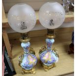 A pair of Napoleon III Paris porcelain ormulu mounted oil lamps, complete with clear glass etched