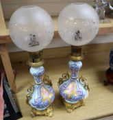 A pair of Napoleon III Paris porcelain ormulu mounted oil lamps, complete with clear glass etched