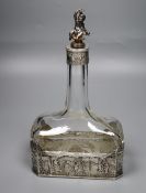 A late 19th/early 20th century German Hanau white metal mounted glass decanter, with figural