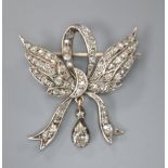 A Victorian yellow metal and old cut diamond set winged ribbon bow drop brooch, 28mm, gross 4.9