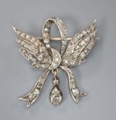 A Victorian yellow metal and old cut diamond set winged ribbon bow drop brooch, 28mm, gross 4.9