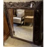 A carved oak framed wall mirror, width 89cm, height 112cm