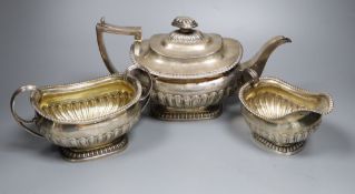 A George III demi fluted silver three piece tea set, by Emes & Barnard, London, 1811, with