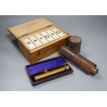 A Victorian cased microscope slides, a leather-cased three drawer telescope and a leather-cased