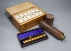 A Victorian cased microscope slides, a leather-cased three drawer telescope and a leather-cased