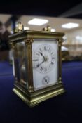 A French corinthian pattern gilt brass carriage clock with alarm, c.1900, height with handle up 16.