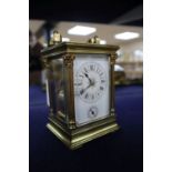 A French corinthian pattern gilt brass carriage clock with alarm, c.1900, height with handle up 16.