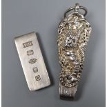 A silver money clip and a white metal chatelaine clip.