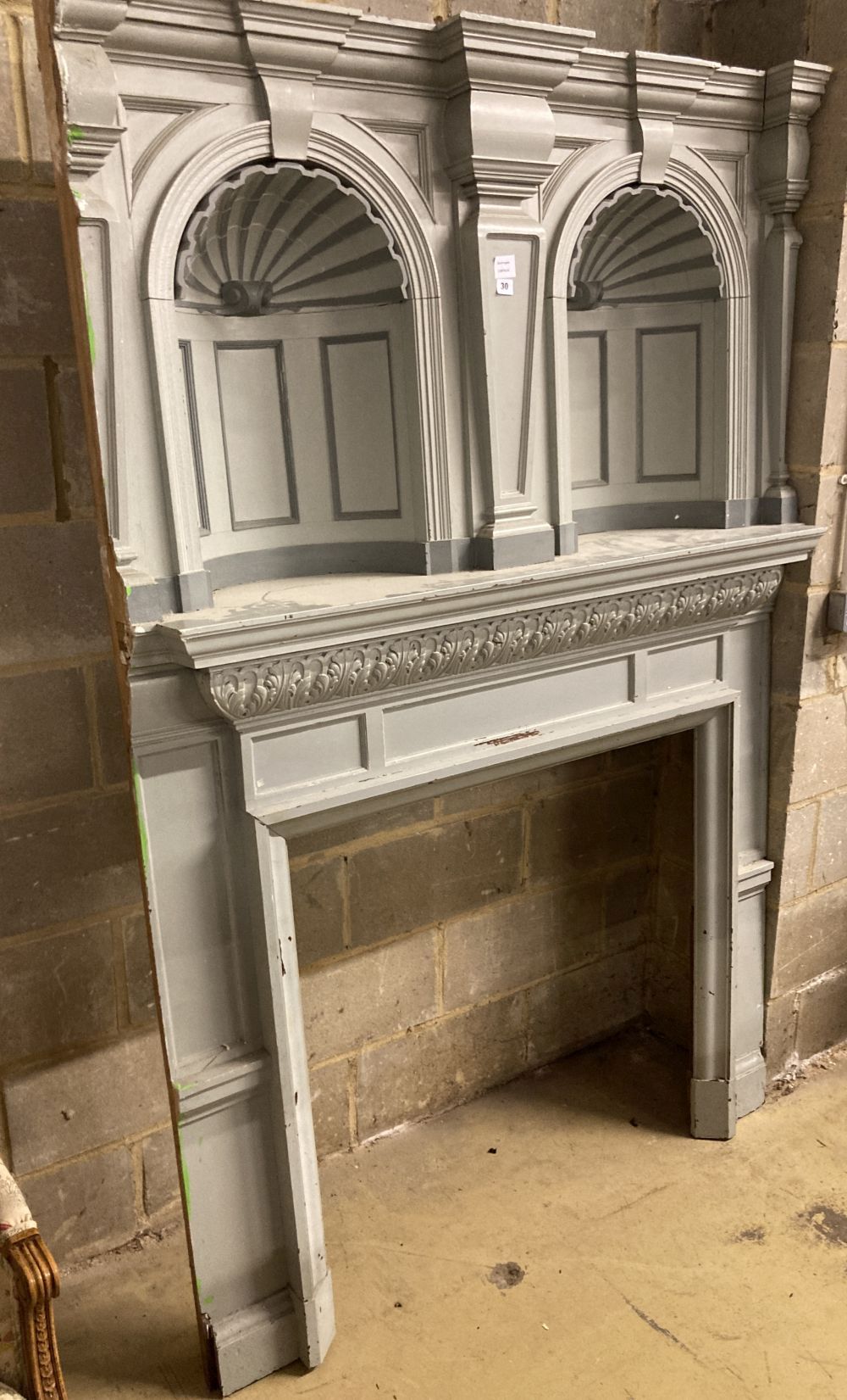 An early 20th century painted pine fire surround with double niche, width 134cm, depth 41cm,