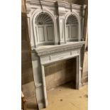 An early 20th century painted pine fire surround with double niche, width 134cm, depth 41cm,