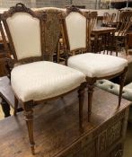 A pair of Victorian carved walnut salon chairs