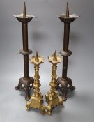 A pairs of brass pricket candlesticks, height 40cm and a pair of bronze pricket candlesticks, height