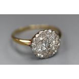 A mid 20th century yellow metal and circular diamond cluster ring, size Q, gross 2.1 grams.