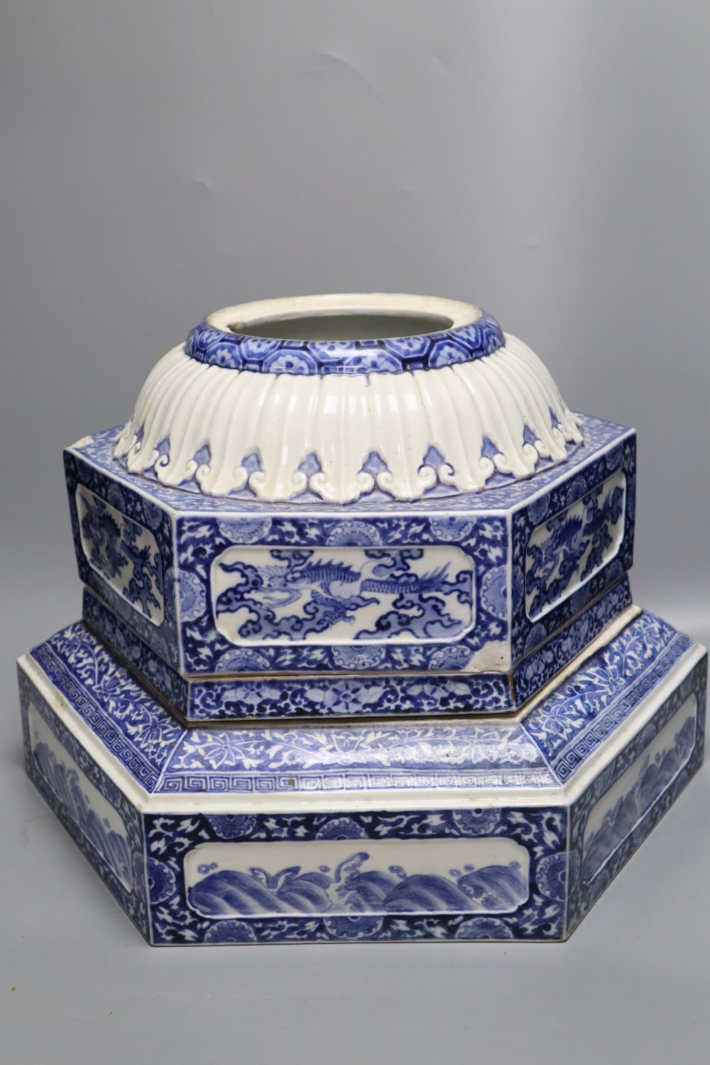 Two Japanese blue and white Arita porcelain hexagonal plinth bases, c.1900, largest 41cm wide