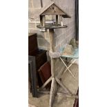 A wooden bird house on stand