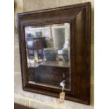 An 18th century style cushioned framed wall mirror, 56 x 63cm