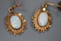 A pair of modern yellow metal and oval white opal set drop earrings, 20mm, gross 1.4 grams.