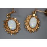 A pair of modern yellow metal and oval white opal set drop earrings, 20mm, gross 1.4 grams.