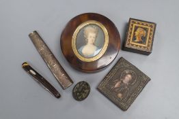 A circular tortoiseshell box, cover inset with portrait miniature, a miniature white metal icon