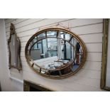 An Edwardian oval gilt marginal framed wall mirror, 111 x 74cm