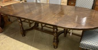 An early 18th century style French oak extending dining table, with two leaves, 268cm extended,