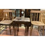 A nest of three walnut tea tables and a pair of early 20th century ash comb back dining chairs