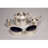 An Edwardian silver oval mustard and four other small silver condiments.