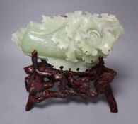 A Chinese bowenite jade carving of a cabbage and a rootwood stand, overall height 24cm