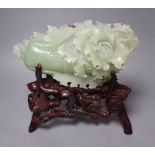 A Chinese bowenite jade carving of a cabbage and a rootwood stand, overall height 24cm