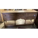 A George III style oak low dresser, width 182cm, depth 43cm, height 89cm