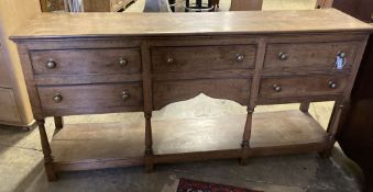 A George III style oak low dresser, width 182cm, depth 43cm, height 89cm