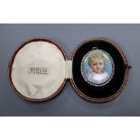 A late Victorian yellow metal and diamond set oval portrait miniature, in fitted gilt tooled leather