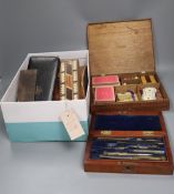 An oak cased games compendium, cased drawing instruments, binoculars, a Tunbridge ware cribbage