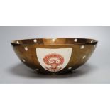 A large Gray's pottery copper lustre American armorial bowl, printed with shield crests in iron red,
