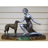 U.Cipriani - An Art Deco style figure of a kneeling lady and a dog, signed, (patinated spelter),