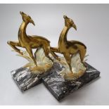 A pair of Art Deco cast metal deer bookends, on black veined marble plinths, height 21cm