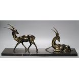 Two Art Deco cast gilt metal gazelles, on black veined marble plinth, 55cm