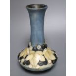 A Moorcroft matt glazed leaf and berry bottle vase, c.1930, 20.5cm high