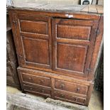 An 18th century panelled oak hanging cupboard, width 130cm, depth 64cm, height 180cm