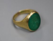 An early 20th century 18ct gold, and intaglio chrysophase? oval ring, carved with the head of a lady