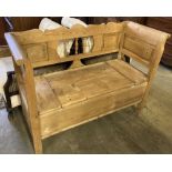 A late 19th century Continental pine box seat settle, width 124cm, depth 48cm, height 91cm
