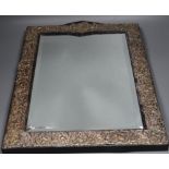 A large repousse sterling mounted easel mirror, overall height 56.3cm.