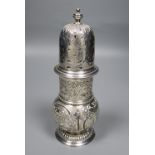 A late Victorian repousse silver sugar caster, embossed with fish, hounds and swan amid foliage,