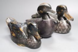 Three painted wood decoy ducks with glass inset eyes, one incised mark C. H., largest 29cm long