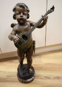 A patinated bronze statuette, cherub playing a lute, base signed, 58cm