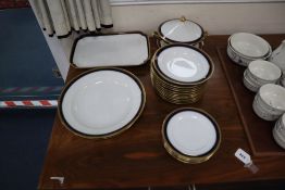 A German part dinner service by F. A. Schumann, blue-bordered and heightened in gilt (22 pieces)