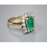 A modern 18ct gold, emerald and diamond rectangular cluster ring, size L, gross 5 grams.CONDITION: