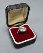 An Art Deco style 18ct white metal and diamond cluster ring, set with two rectangular and nine round