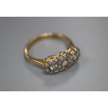 An 18ct yellow and white gold diamond triple cluster ring, size L/M, gross 2.7g